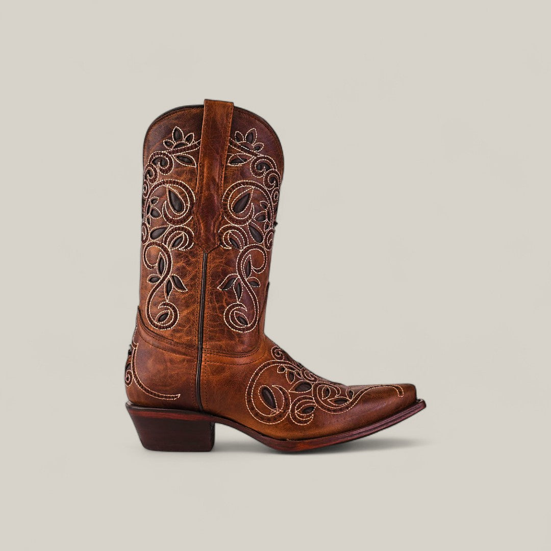 The Gina - Brown - Snip Toe is a premium leather cowboy boot featuring intricate white embroidery and a snip toe, shown in profile against a light beige background.