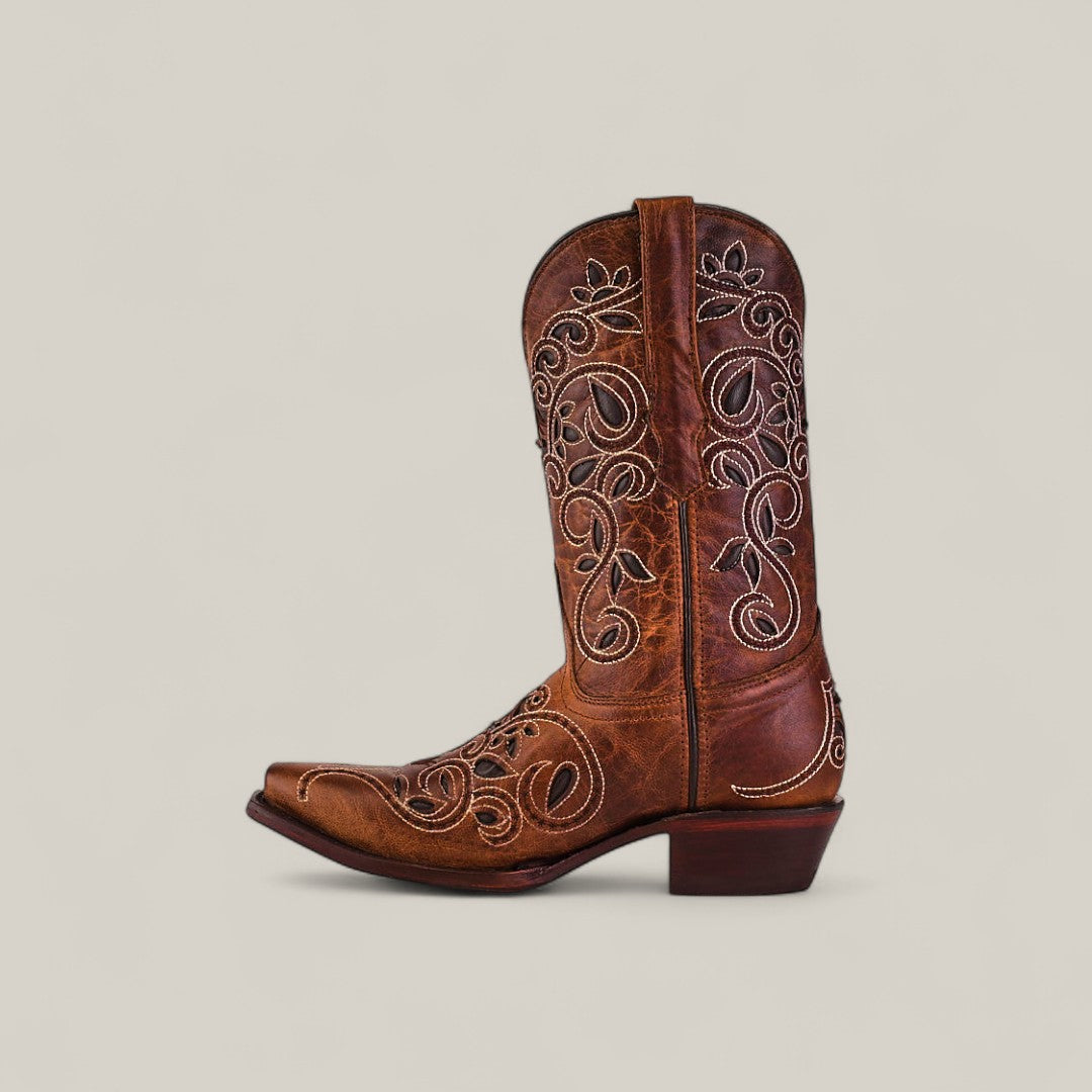 The Gina - Brown - Snip Toe boot features brown cowhide leather, decorative white stitching, a pointed toe, and a short angled heel, shown against a simple light background.