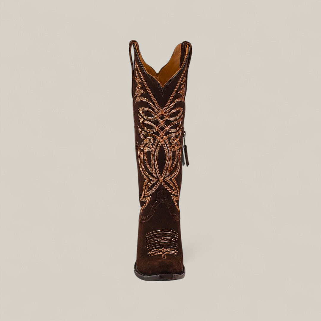 The Kellie Suede Brownie Leather Sole Tall Shaft Snip Toe boot is shown from the front, featuring dark brown suede and detailed light tan embroidery on a plain light background.
