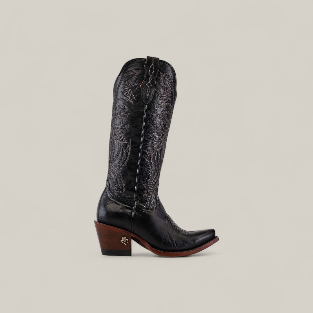 The Kellie Clayton Black Leather Sole boot features a tall shaft, snip toe, and is shown in black with detailed stitching and a dark wooden heel against a plain light beige background.