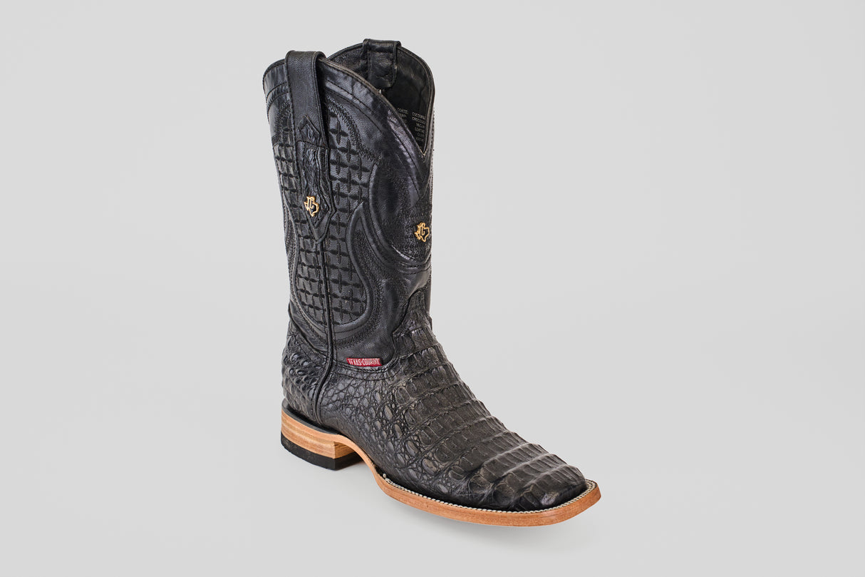 The Exotic Caiman Horn Back - Black - Square Toe boot, featuring textured caiman leather with a crocodile pattern, tan sole, and decorative stitching, is displayed against a plain light gray background.