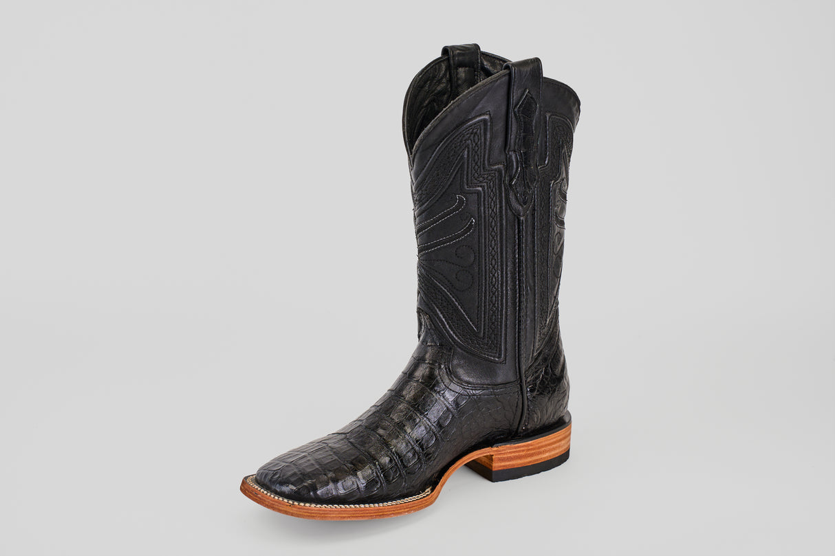 The Exotic Caiman Belly - Black- Square Toe boot features a single black caiman leather upper with an alligator-like texture, decorative shaft stitching, and a light brown leather sole, shown on a plain light gray background.