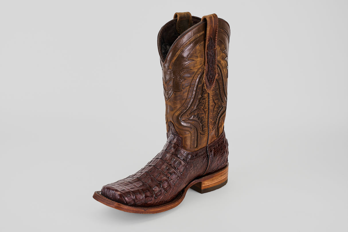 The Exotic Caiman Hornback - Brown - Rodeo Toe is a single cowboy boot made from genuine caiman leather with a textured pattern, square (rodeo) toe, and wooden heel, shown on a light gray background.