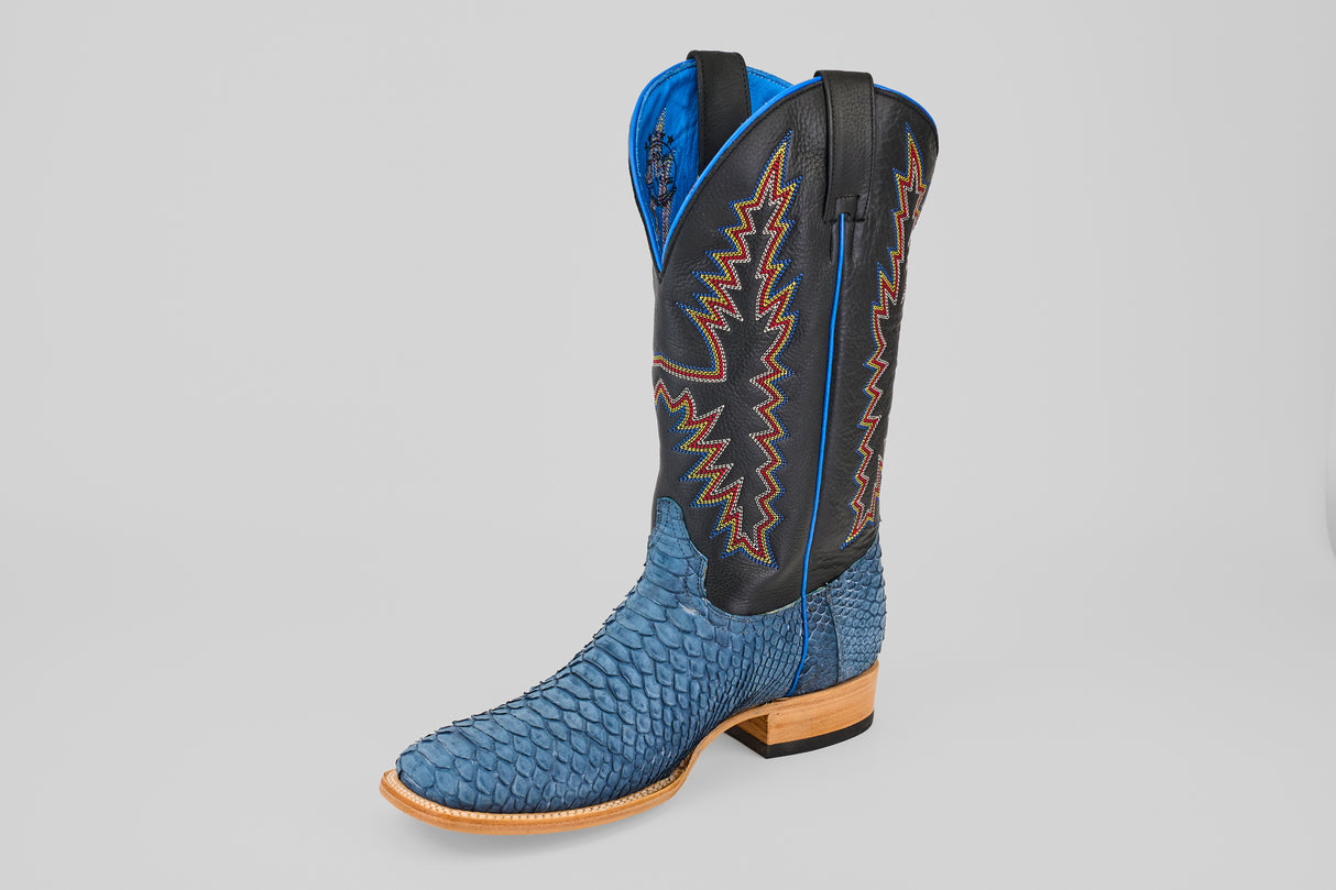 The Kingsley - Blue Jeans - Square Toe cowboy boot features blue snakeskin, a light brown sole, black leather shaft, blue lining, and colorful zigzag stitching—ideal for those seeking standout mens boots from the Diamond Collection.