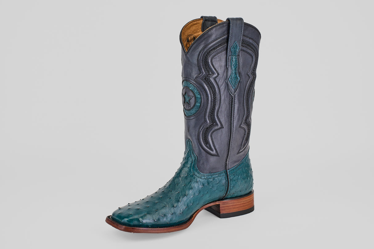The Austin - Gasoline Green - Square Toe is a men's western boot with a teal ostrich leather foot, dark gray shaft with decorative stitching and star design, wooden heel, and pull straps.