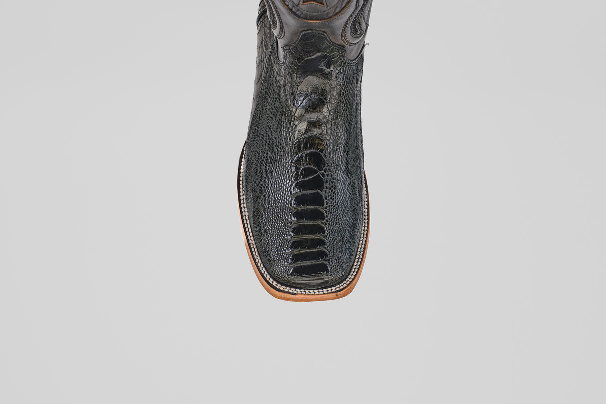 The Austin Leg - Black - Square Toe features textured black leather and detailed stitching, shown from above on a white background—these stylish boots bring a modern edge to classic Western style.