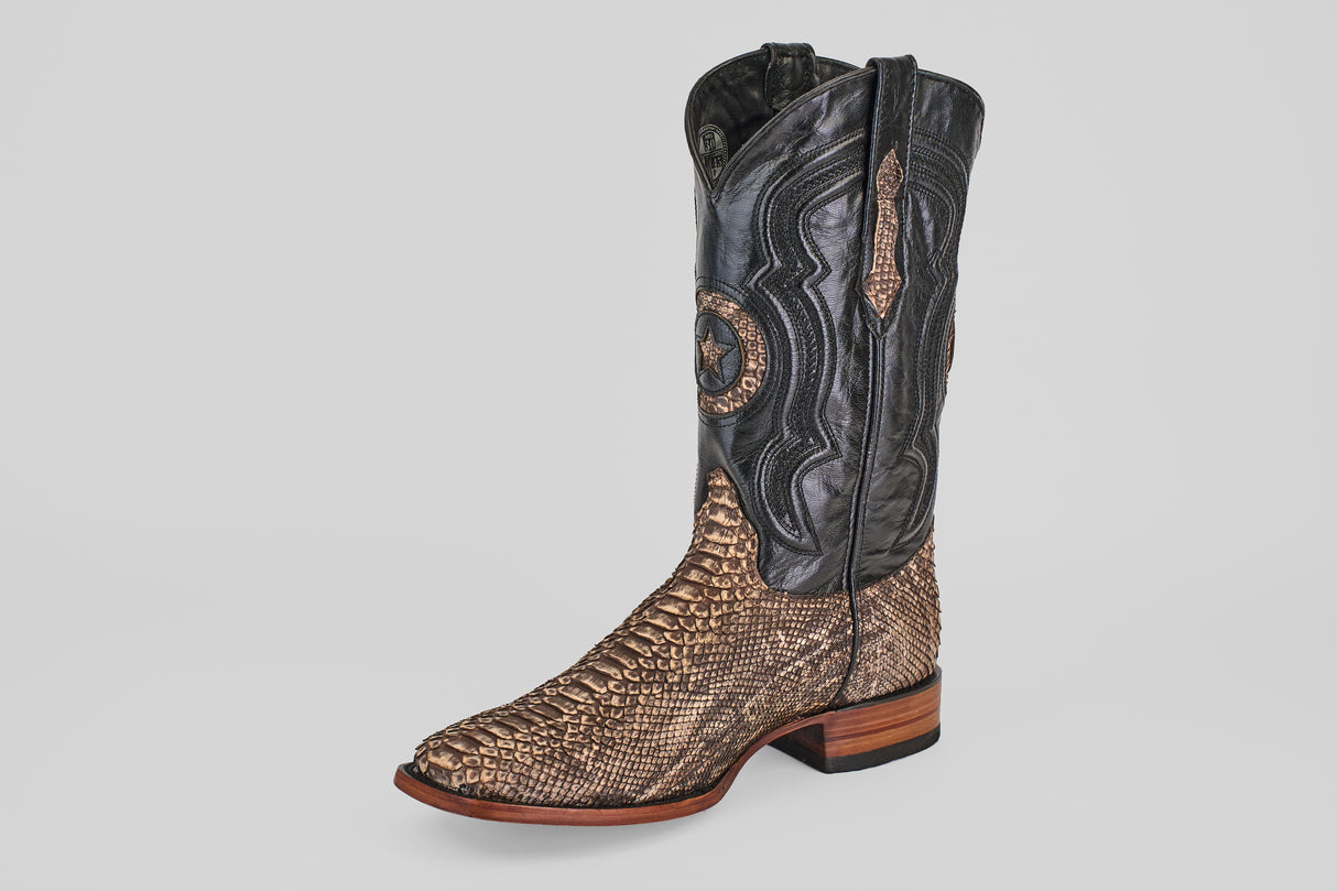 The Tanner – Rustic Bone – Square Toe boot features a tan snakeskin lower, a black intricately stitched leather upper, Western craftsmanship, wooden sole, and low heel, beautifully displayed against a plain white background.
