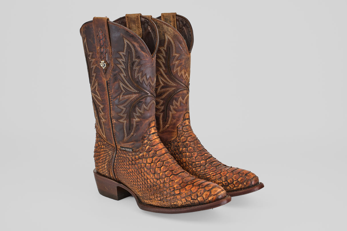The Tanner – Chestnut – Round Toe boots feature brown Python leather with intricate shaft stitching and a textured scale pattern, embodying classic western style against a plain light background.
