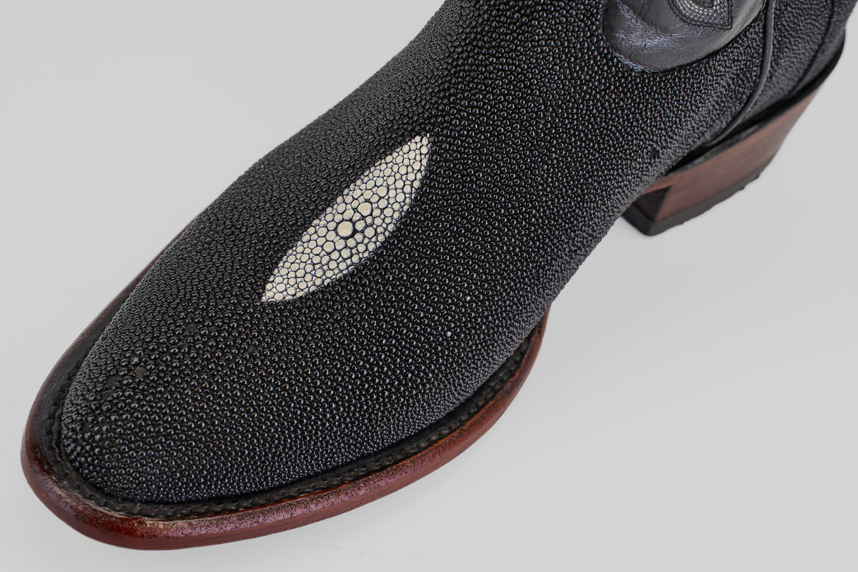 A close-up of the Ranger – Black – Round Toe boot, featuring black stingray leather, a smooth oval white accent, and a wooden sole—ideal for anyone seeking unique, stylish black round toe boots.