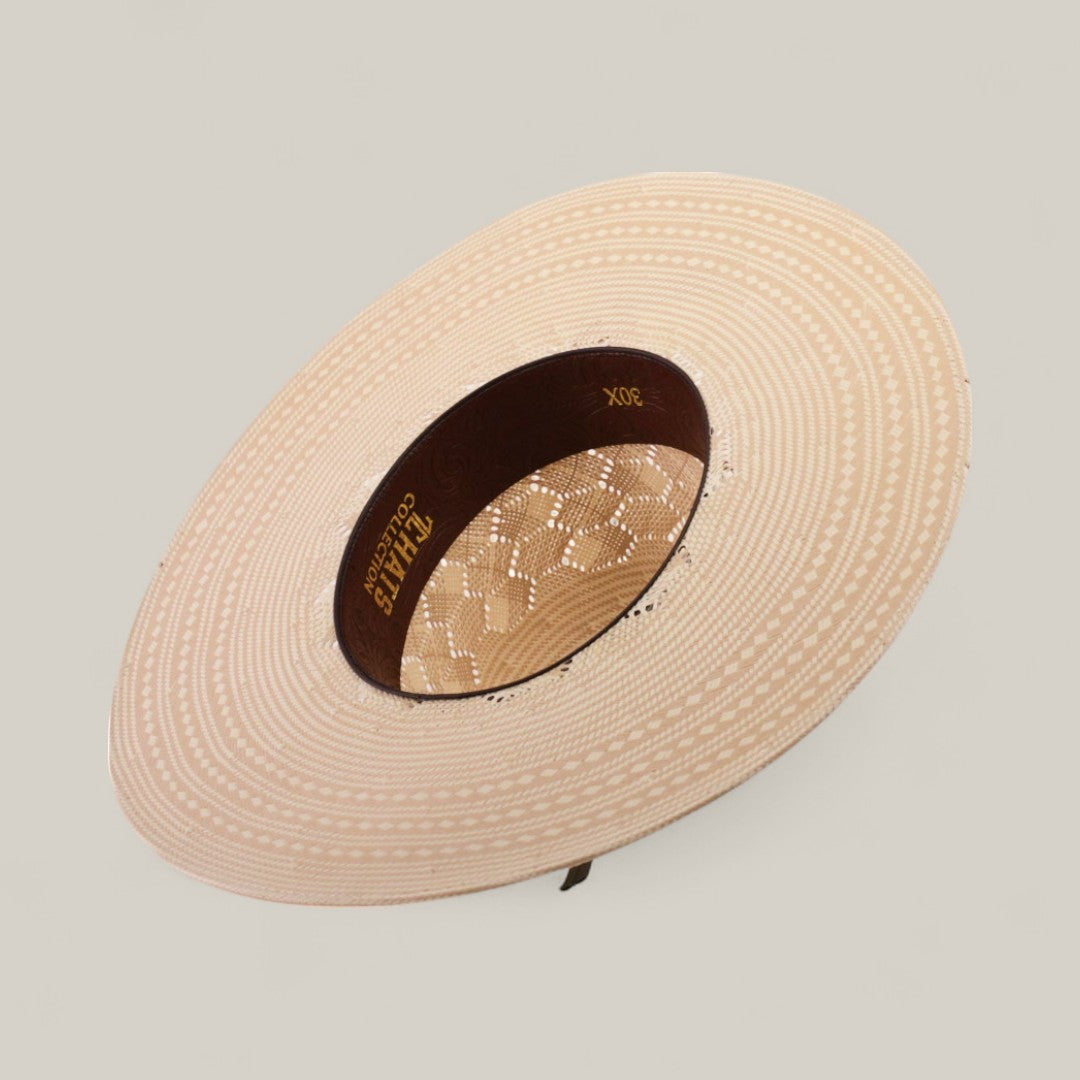 The 30X Hexagon - Open Crown is a beige, wide-brimmed straw hat featuring intricate patterns and an open lace crown, viewed from above against a light background.