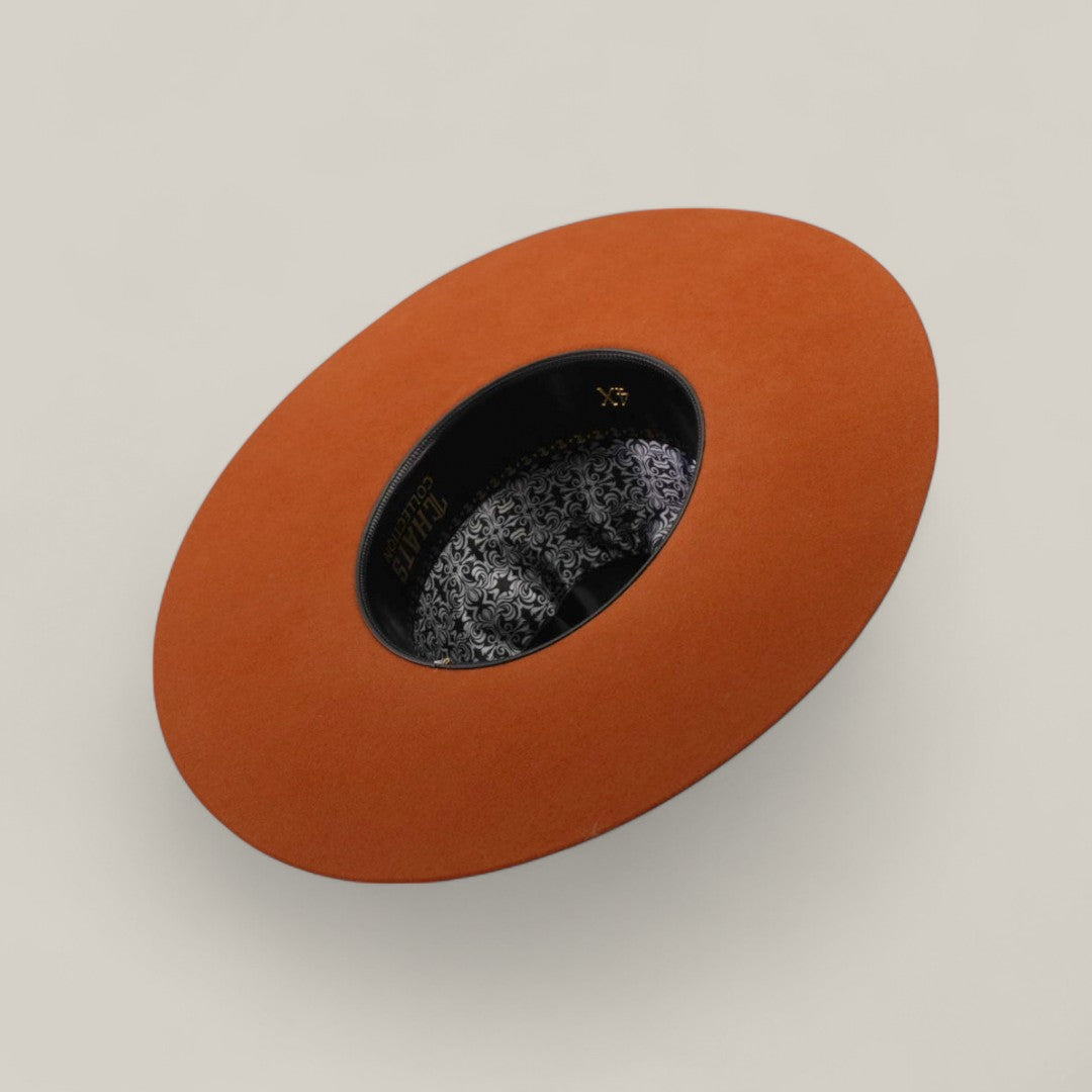 A 4x - Brick - TC Hats Open Crown Texana is shown from above, featuring a black decorative band with gold text and a floral-patterned inner lining. The background is plain and light-colored.