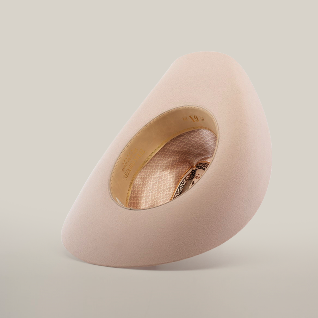 The 6X Country Belly is a plush, cream egg-shaped chair made from premium sheep wool. It features a large oval cutout showcasing a patterned interior and circular seating. Its minimalist modern design stands out against a white background.