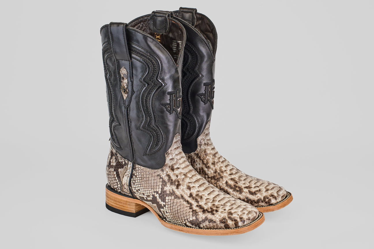 A pair of cowboy boots with black uppers and light brown, textured snakeskin-patterned lowers, shown from the front and side on a plain background.