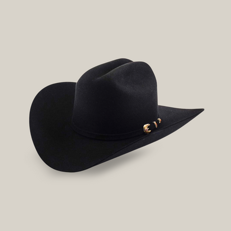 A black felt cowboy hat with a wide brim, a curved crown, and a decorative hatband featuring small gold and brown accents, displayed on a light beige background.