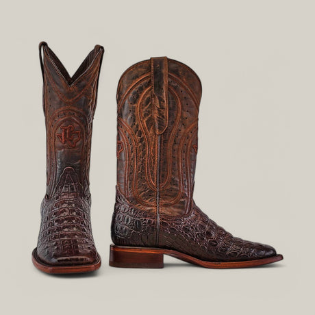 The Alligatoar Horn Back Print Brown boots display intricate embossed designs with a logo, resembling alligator horn back skin. Their square toe and shiny finish can be seen from both front and side views.