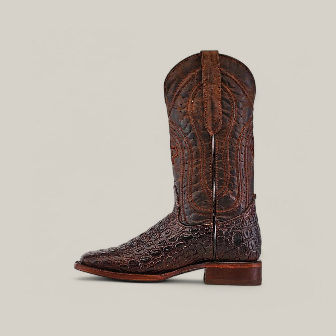 The Alligatoar Horn Back Print Brown - Square Toe boots feature intricate stitching, a textured crocodile-like pattern, and pull straps. With a classic western design and medium heel, these brown cowboy boots are showcased against a plain beige background.