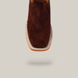 A close-up of the Brown Suede - Platinum - Square Toe boot highlights its square toe and decorative edge stitching, set against a plain light background.