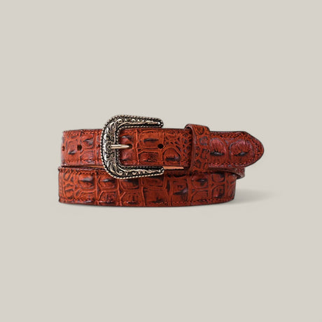 The Caiman Print Cogñac Belt - Texas Buckle for Kids, featuring a crocodile texture and ornate Texas buckle, is displayed rolled up against a gray background.