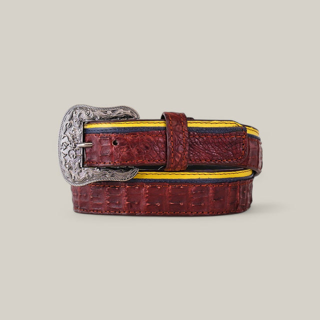 The Exotic Caiman Wine Belt, with its textured brown leather, features a large platinum buckle and yellow-blue accented edges, creating a striking contrast that makes it a true statement piece.