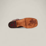 The Jonh - Cogñac - Square Toe boot is displayed sole-up, revealing the Texas A&M logo and “TEXAS COUNTRY” engraved on the sole. The heel shows a red TEXAS COUNTRY logo and a small Texas outline.