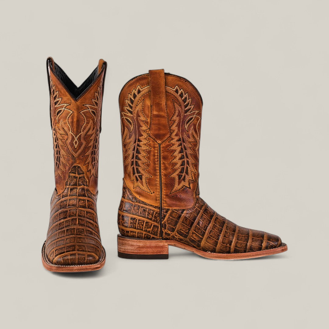 The Ross - Orix - Square Toe boots feature brown leather with detailed stitching and a textured square-toe design. One boot is shown front-facing and the other from the side, both set against a plain, light background.