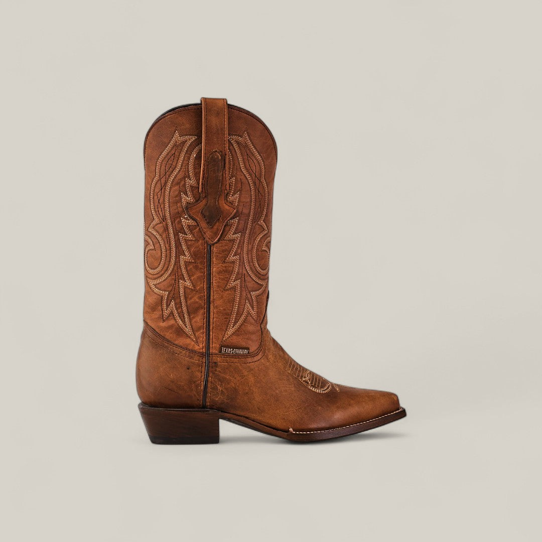 The Fresno - Tabaco - Snip Toe boot features quality brown cowhide, decorative stitching, and a pointed snip toe, displayed in profile on a plain light background—a showcase of timeless style and craftsmanship.
