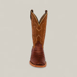 The Exotic Caiman Belly Tail - Brandy - Square Toe cowboy boot features decorative shaft stitching and a textured, dark Caiman Belly foot, displayed from the front on a plain, light background.