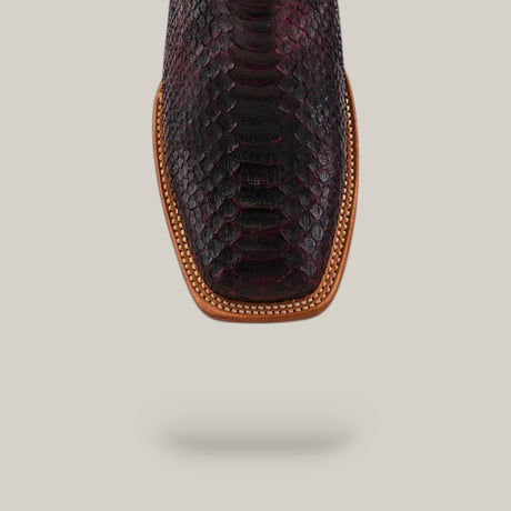 Close-up of the Exotic Python - Blackcherry - Square Toe boot, highlighting its dark textured python skin, brown leather trim, and intricate stitching from the Platinum Collection against a light background.