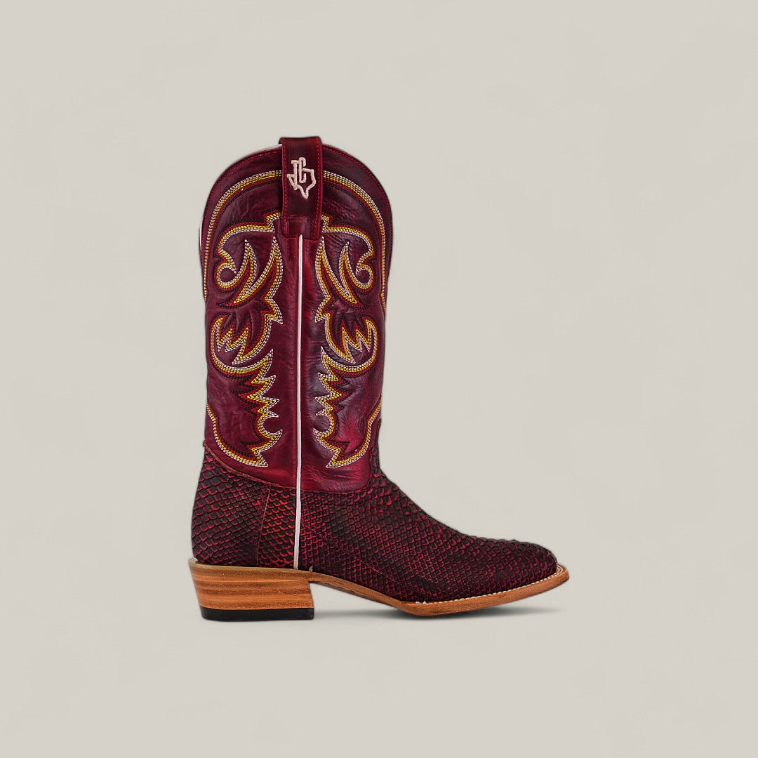 A single Exotic Python - Cherry Nobuck - Square Toe cowboy boot with red and black nobuck, yellow and red stitching on the shaft, wooden heel, and a square toe is displayed against a plain beige background.