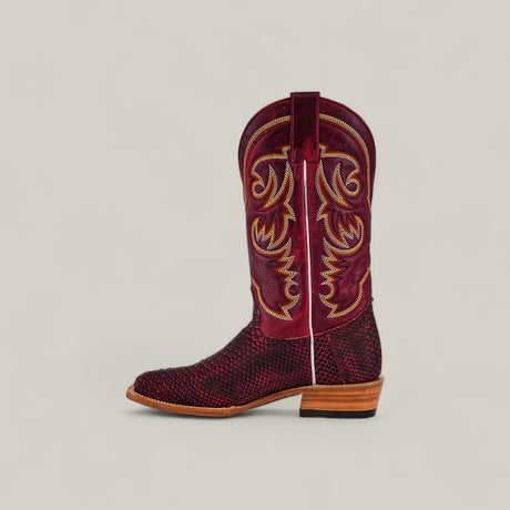 The Exotic Python - Cherry Nobuck - Square Toe cowboy boot features maroon and black nubuck with yellow stitching, a square toe, textured exotic python leather, and a wooden heel, displayed on a plain light background.