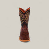 The Exotic Caiman Belly Tail Cognac - Square Toe Kids Boots feature a brown caiman-textured foot, a black shaft with orange and yellow stitching, and are shown front-facing on a plain light background.