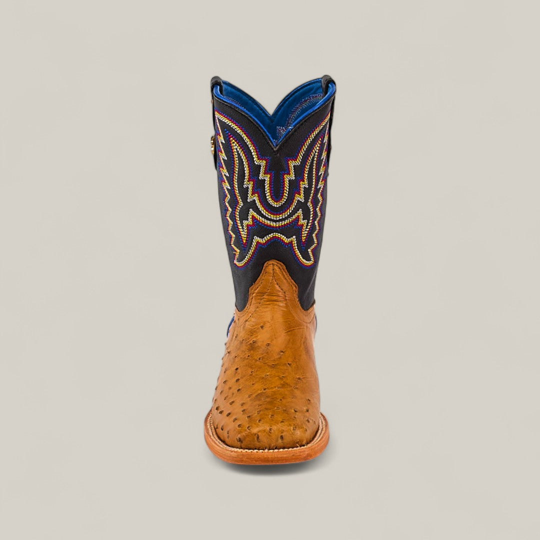 The Exotic Full Quilt Ostrich Fawn - Square Toe - Kids Boot features a fawn ostrich foot, dark blue shaft, and colorful embroidery, displayed from the front against a plain light background.