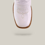 The Amara White Square Toe Kids Boots feature premium white leather, brown stitching, and decorative toe patterns—an elegant blend of style and comfort, shown from above against a light gray background.