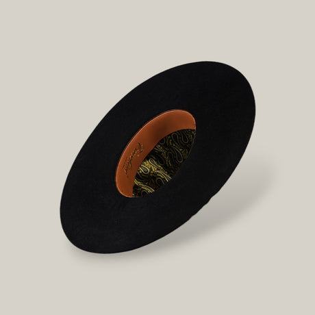 The 10X Grizzly - Tacchino is a black felt open crown hat, shown from above to display its tan leather inner band and green and gold paisley lining, set against a plain beige background.