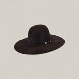 The 10X Grizzly - Tacchino is a wide-brimmed black open crown felt hat featuring a rounded crown and a small silver buckle on the band—a timeless luxury accessory displayed against a plain light background.
