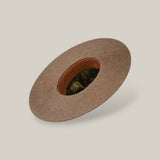 The 10X Grizzly - Tacchino is a brown, wide-brimmed felt hat with an open crown and top, featuring a patterned inner lining and leather band, displayed on a plain light background.