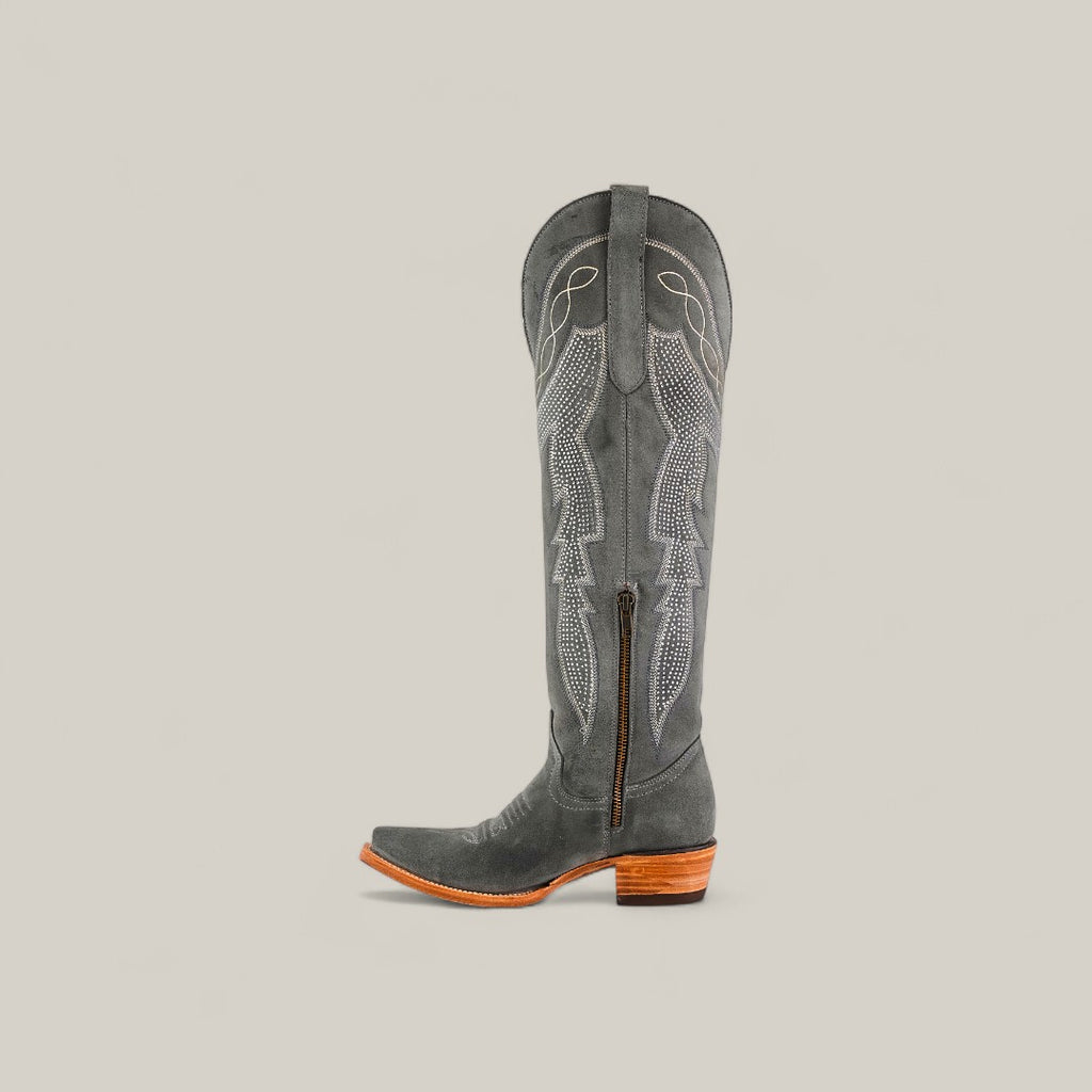 The Celine Gray - Tall Shaft - Snip Toe boot features dark gray suede, decorative stitching, a side zipper, pull strap, snip toe, and a wooden stacked heel, shown against a plain light background.