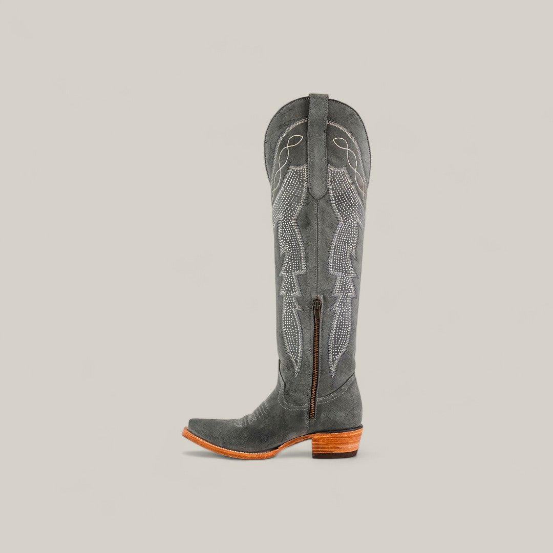 The Celine Gray - Tall Shaft - Snip Toe boot features dark gray suede, decorative stitching, a side zipper, pull strap, snip toe, and a wooden stacked heel, shown against a plain light background.