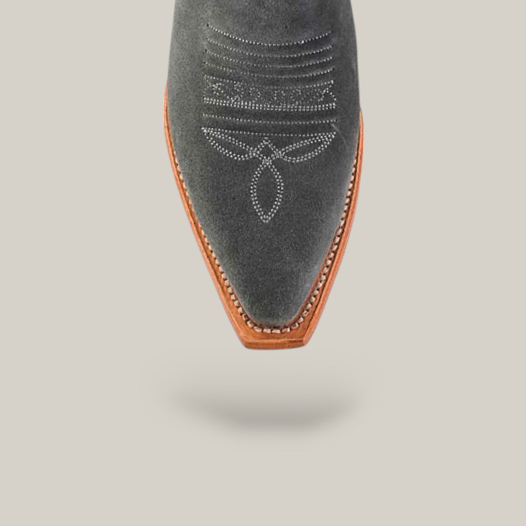 A close-up of the Celine Gray - Tall Shaft - Snip Toe boot shows its pointed gray suede toe, white decorative stitching, and brown leather outsole against a light beige background.