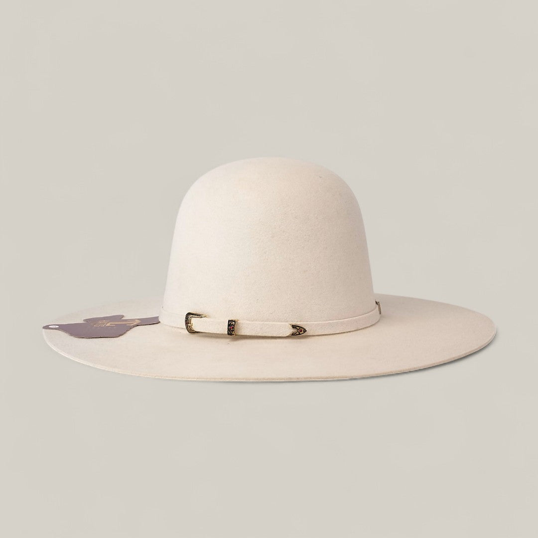 The 10x White - TC Hats is a wide-brimmed, light beige felt Western hat featuring a simple decorative band with small metallic details, shown against a plain light background.