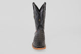 A single Exotic Caiman Horn Back boot in black with a square toe, tan sole, and decorative stitching, photographed from the front against a plain white background.