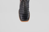 A close-up, top-down view of the Exotic Caiman Horn Back - Black - Square Toe boot highlights its textured reptile-like pattern and decorative welt stitching, showcasing the distinctive style of square toe boots.