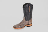 The Exotic Caiman Horn Back - Serpentine - Square Toe boot features a textured brown lower, black stitched upper shaft, and a light-colored sole, showcased against a plain gray background.