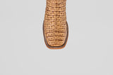 A close-up of the toe of the Exotic Caiman Horn Back - Antique - Square Toe boot, featuring a striking crocodile pattern in tan, set against a plain light gray background.