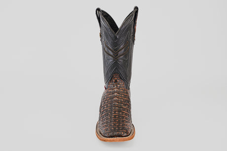 The Exotic Caiman Horn Back - Roma - Square Toe boot features a textured brown caiman-like lower and a black stitched upper shaft, displayed front-facing against a plain light background.