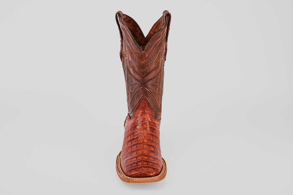 The Exotic Caiman Belly - Brandy - Square Toe boot, featuring detailed stitching and textured caiman leather, is shown from the front on a plain light gray background.