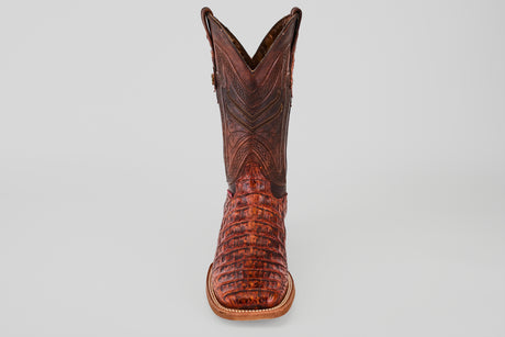 The Exotic Caiman Horn Back - Smoke Cogñac- Square Toe boot features textured caiman leather with decorative stitching, shown from the front against a plain light gray background.