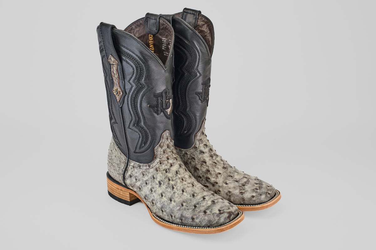 The Exotic Full Quilt Ostrich - Nicotine - Square Toe boots feature light, textured full quilt ostrich leather on the foot, a darker smooth shaft with decorative stitching, and a stacked wooden heel.