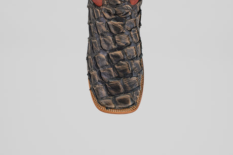 Close-up of the toe of the Butch - Caramel - Square Toe cowboy boot featuring decorative stitching and a textured pattern, crafted from luxurious Pirarucu leather for an exotic look.