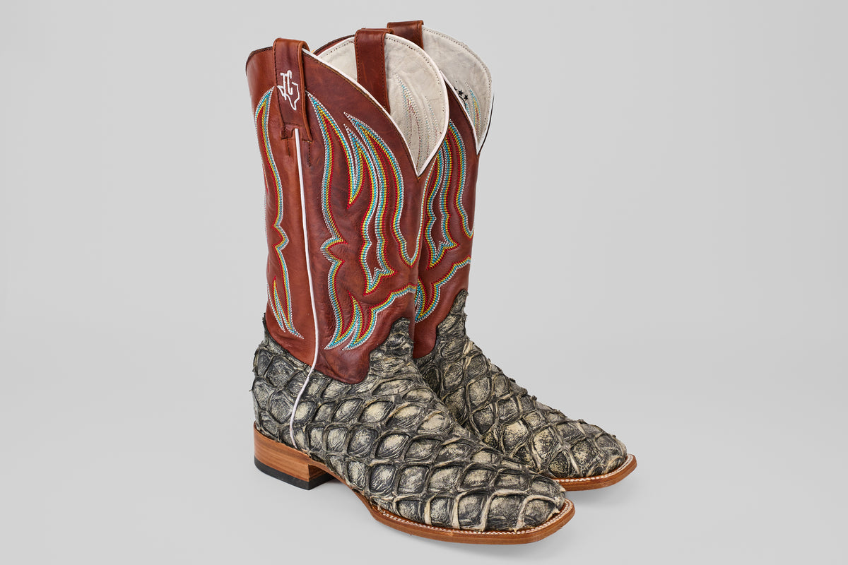 The Robinson - Newspaper - Square Toe boots are limited edition cowboy boots with textured gray Purarucu leather on the foot and dark red shafts with colorful stitching, shown against a plain light background.